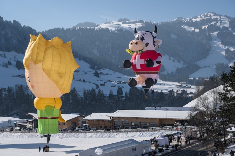 Montgolfières survolant un paysage enneigé des Alpes suisses